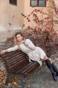 a woman sitting on a bench in front of a building