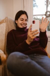 An Woman in a Turtleneck Having a Video Call