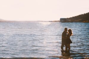 couple standing on water during daytime