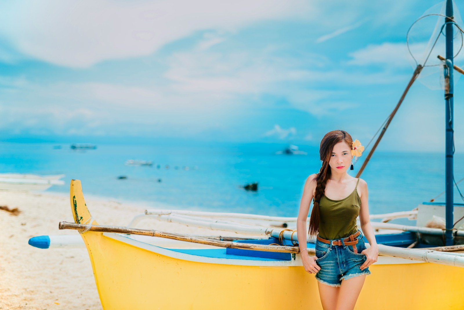 woman standing in front of yellow boat
