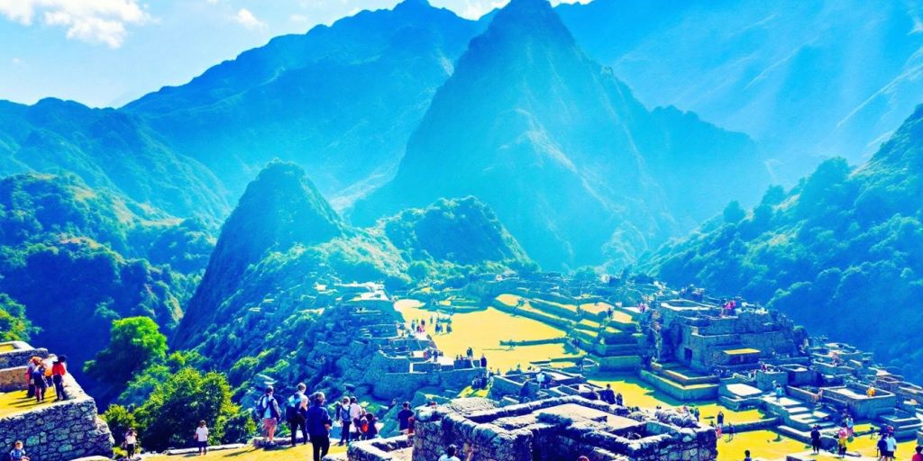 Machu Picchu with travelers and lush green mountains.